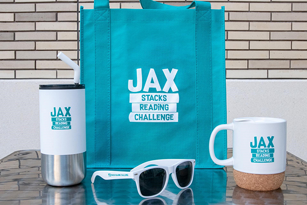 image of JaxStacks prizes for reading - bag, mugs, and sunglasses